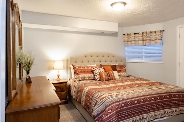 Bedroom 3 in basement with king bed, dresser and closet.