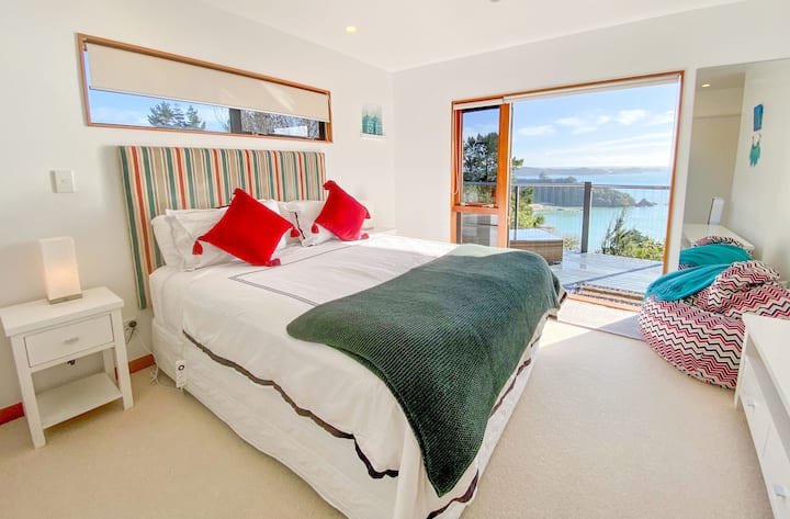 Dormitorio queen con vistas al océano, su propia terraza, asientos exteriores y lujoso baño privado