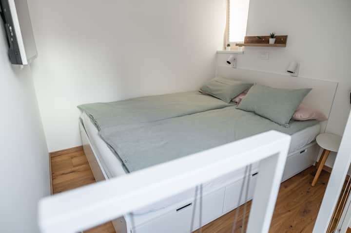 Cosy and bright Air conditioned sleeping area with double bed.