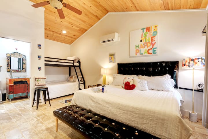 The studio suite is so the happy place with Purple 2 & 3 mattresses, a bathroom with a local artist handmade vanity, a Sticks mirror, and a cool shower.  

Guests love the privacy of this space and the three beds, the king, the queen, and the twin.