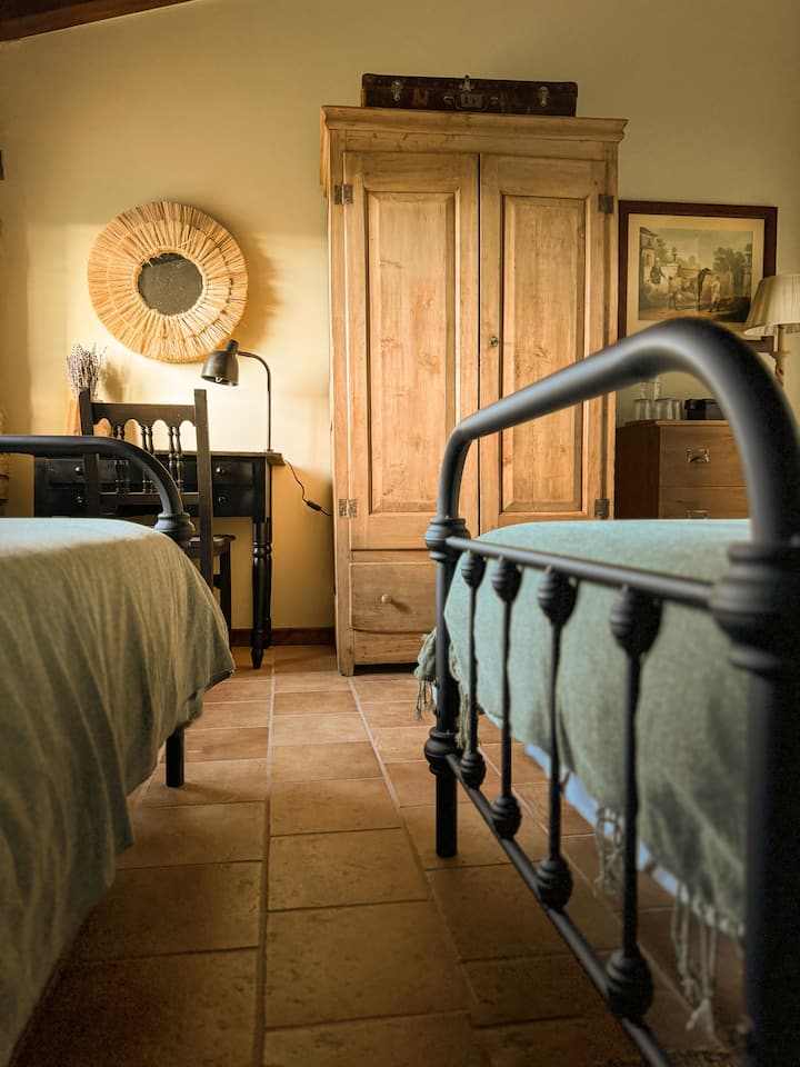 Ლა ‑ ტრიბუს ოთახის ნაწილია სამი სპილენძის საწოლი. Ოთახში არის დიდი კარადა, ტანსაცმლის შესანახი კომოდი და პატარა სამუშაო მაგიდა. 