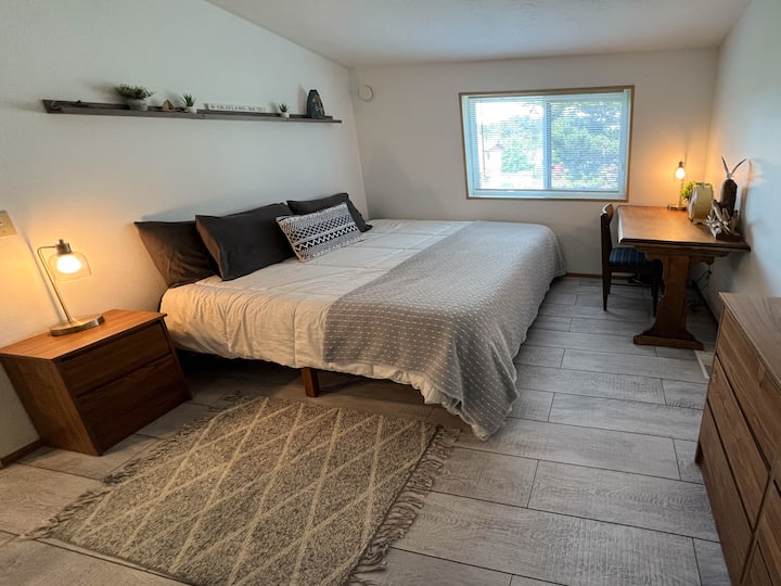 Super Comfy King Size Bed in primary suite with attached bath and a desk for remote working office space.