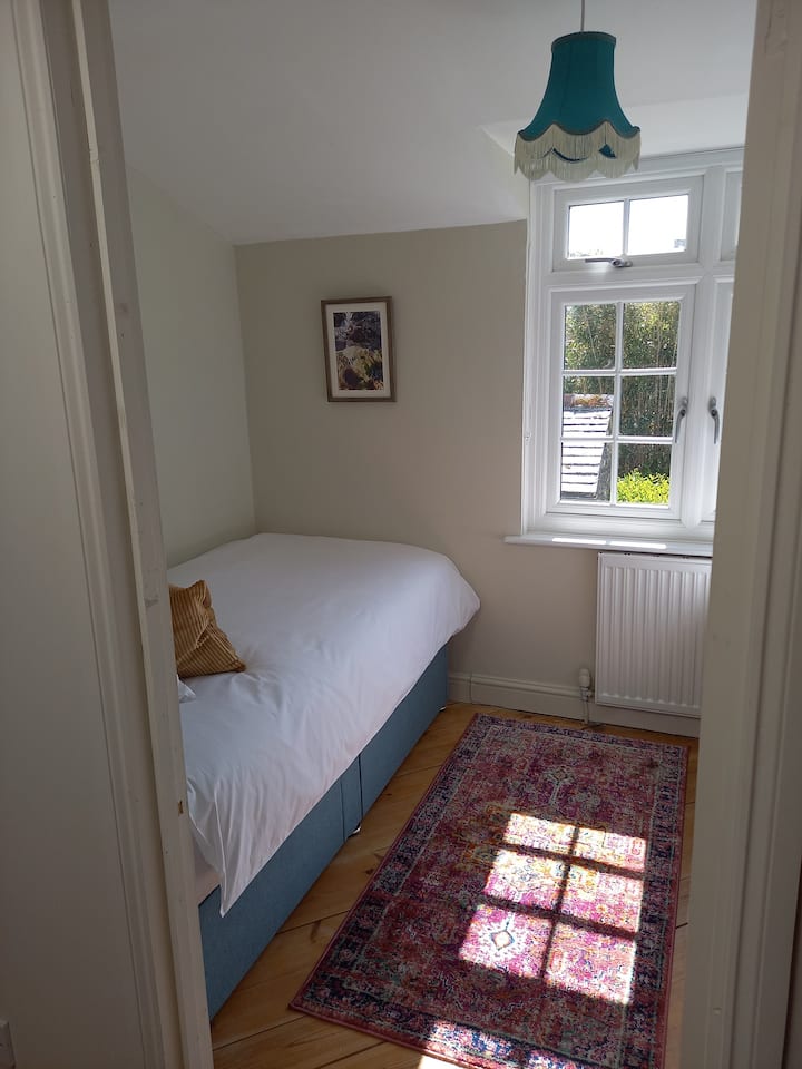 Bedroom 2 with two full size single beds and under bed storage. Countryside views towards Bodmin moor