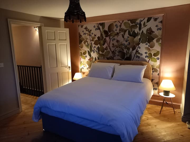 Unique main bedroom with kingsize bed, surface view wallpaper and countryside views