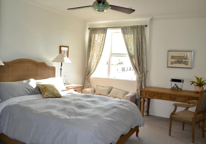 King Size bed, window seating,  and large desk.