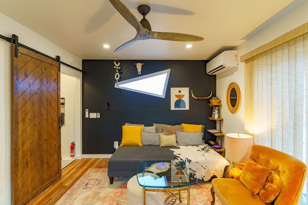 Fungua jiko na sehemu ya kuishi iliyo na mlango wa banda ambao unaweza kufunga ngazi hadi kwenye chumba cha kulala kwa ajili ya mahitaji ya kutosha ya kupasha joto na kupoza wakati nyumba imewashwa. Pia feni ya dari ili kuzunguka hewa. 