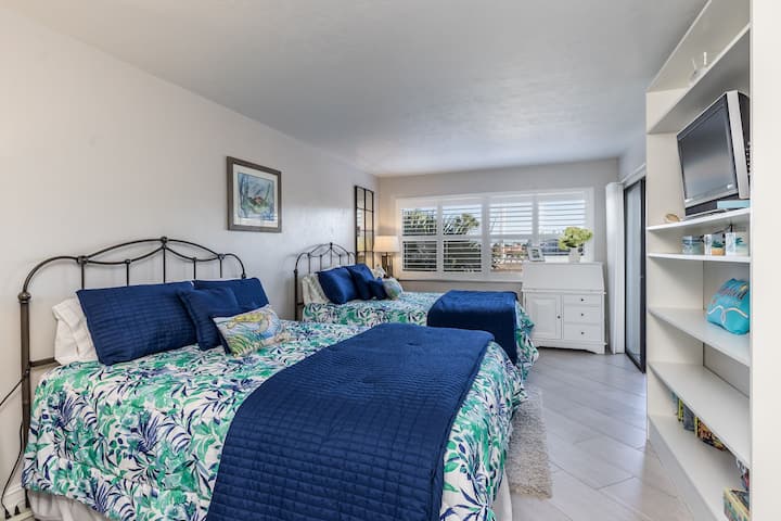 Bedroom has a view of Factory Bay, 2 queen beds, flat-screen tv with cable, closet, and plenty of room for your belongings so you can settle in and feel at home while away in paradise.