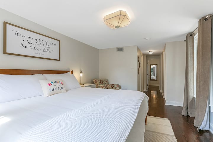 Private and spacious master bedroom with a king sized bed, smart tv, walk in closet, private bathroom, and a door to the back yard.