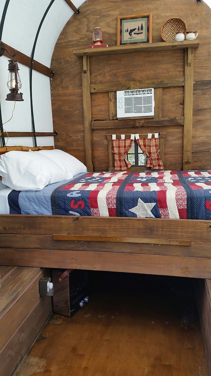 Full size bed in sheepherder wagon.  Pull out table and benches. 