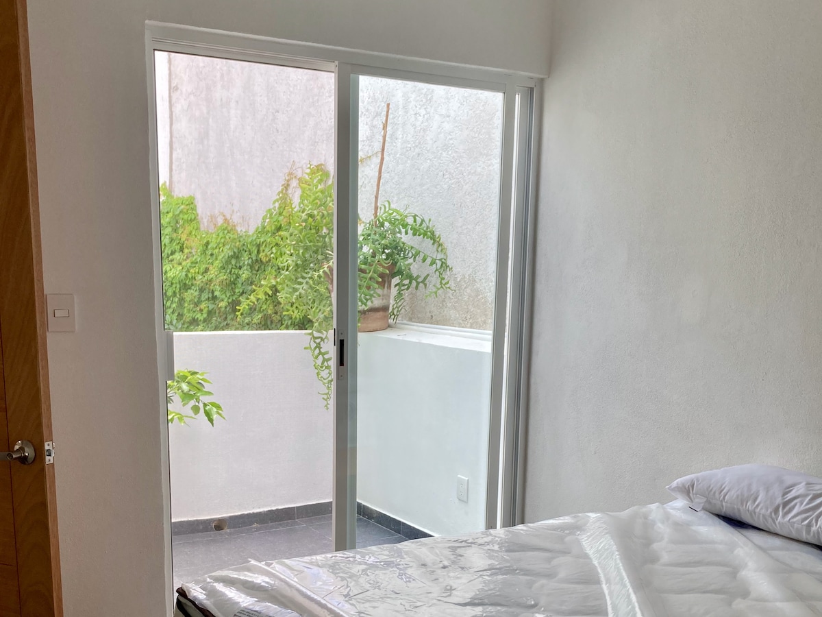 Amplia recámara con pequeña terraza para disfrutar el clíma y aroma de jardín.