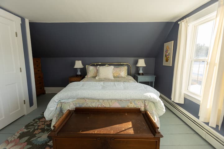 The queen bedroom on the second floor has views of the farm and mountains across the street.