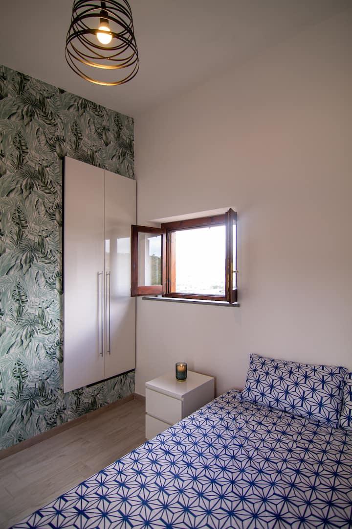 Druhá dvojposteľová spálňa konvertibilná na dve samostatné postele s výhľadom na dedinu.