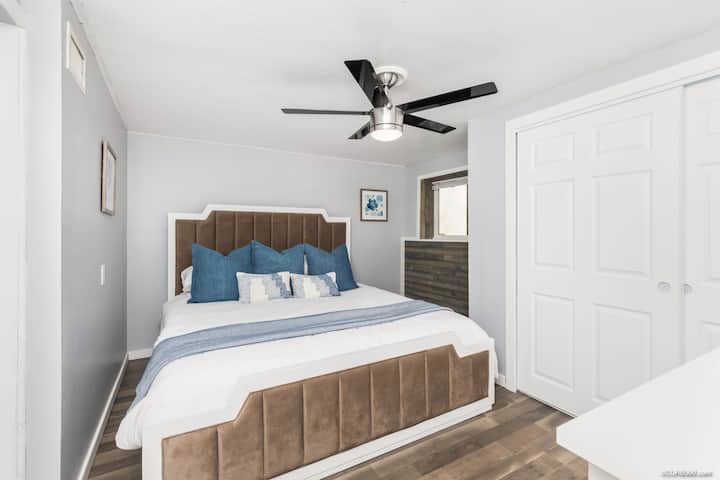 Downstairs bedroom with King Sized Bed and plush bedding. Full-sized double closet. 