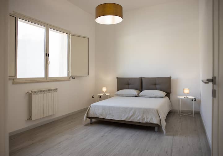 Bedroom with king-size bed, south-facing, spacious with closet and air conditioning. 