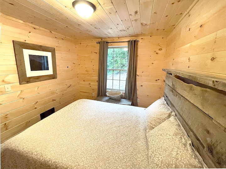 This is our first-floor guest room which features a queen bed with a comfortable memory foam mattress. This bedroom is located to the right of the reading nook, just off the living room.