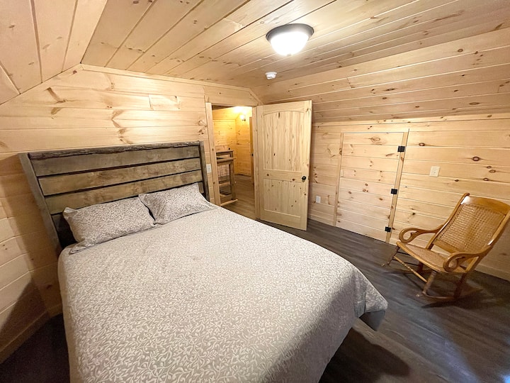 This is the master bedroom that features a queen bed with a comfortable memory foam mattress. What isn't visible in this photo are the french doors that access a second-floor balcony and its private viewing area of See Rocks.