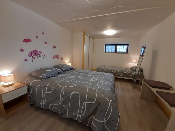 large bedroom with 1 double bed and 1 single bed.