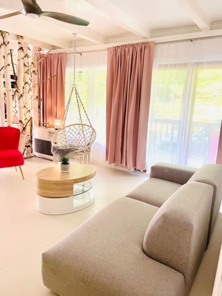 Bohemian living. Enjoy the comfy couch or hanging chair. Perfect for bird watching. 