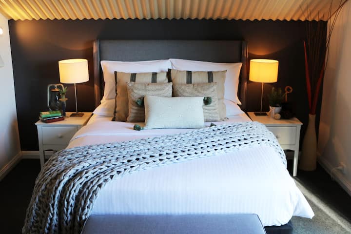 Our super comfy Master Mezzanine Bedroom has a queen sided bed and luxurious hotel quality sheets for your comfort.