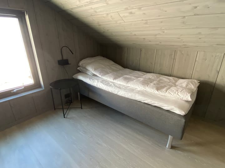 Soverom 5, seng nummer 1 (loftsrom).
Dette soverommet har tre separate senger, alle 90 cm.
Sengelys med integrert mobilholder og lader (USB-A). 