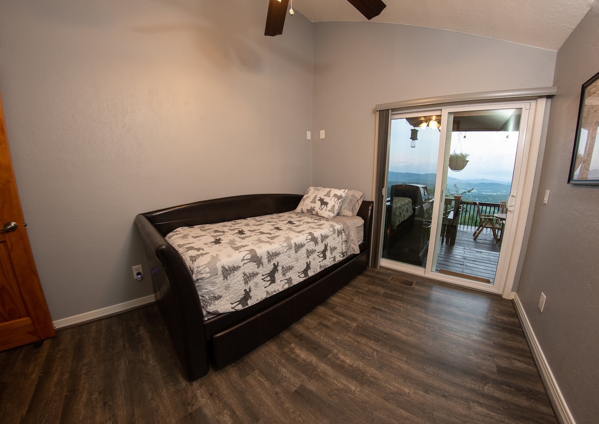 XL Twin Trundle bed (twin mattress underneath that slides out). Sliding door to the east facing deck. 