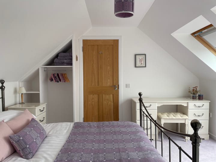 The lavender bedroom, with ensuite shower and fabulous views from the dormer windows.