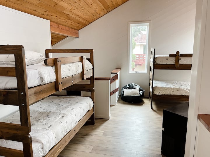 Two sets of bunk beds can sleep four up in the loft, complete with bean bags, coat hooks, and a storage cabinet for clothes, toys, or books. The loft overlooks the great room downstairs and has plenty of windows, one with a view of Chair 22.