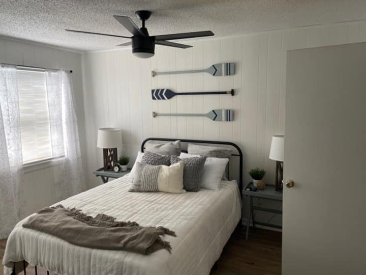 Primary bedroom is tastefully decorated with a very comfortable bed and ceiling fans in each berdroom.