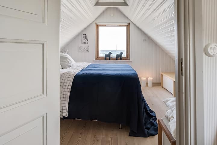 Საძინებელი კომფორტული ორადგილიანი საწოლით და ზღვის ხედით.  