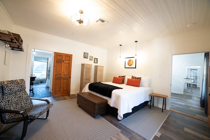 The master bedroom and the master bath view of the creek are amazing.  Spacious, private, a brand new king size bed will have you relaxing in no time.  The master bedroom is just off the dining area to right in this picture with the kitchen beyond.