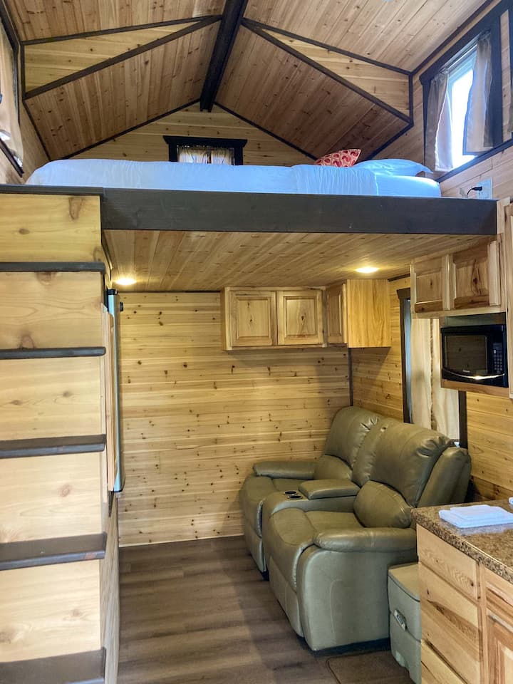 Fully lined with cedar, it smells like walking into a cedar chest! Movie theater recliners and a tv/dvd player for “movie night”. Kitchenette includes sink, microwave, refrigerator and coffee maker. Service for two. Also outdoor grill for cooking 