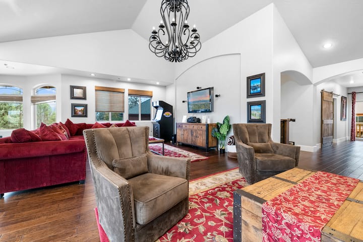 Living Room 2 in the Big Bear Castle offers spacious seating with couches that comfortably fit up to 7 people, creating the perfect spot for gatherings, relaxation, or cozy movie nights with family and friends.