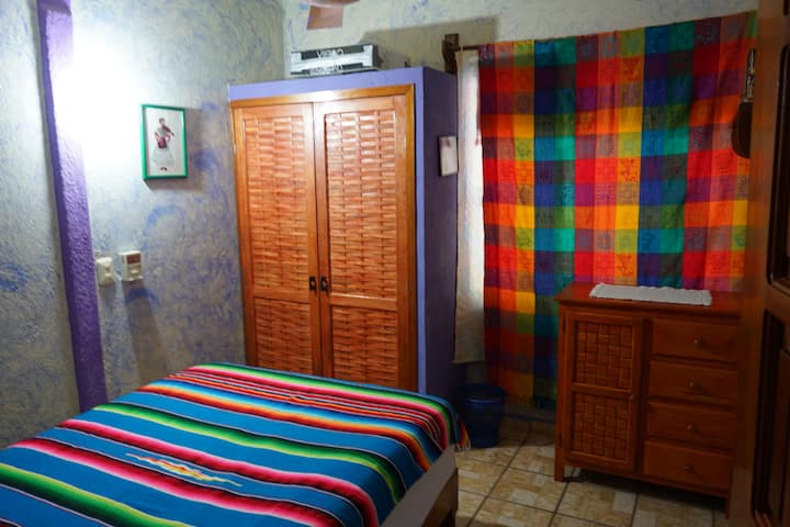 Second bedroom with strong ceiling fan, double bed, closet and chest of drawers
