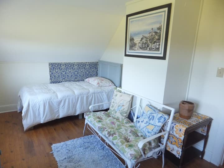 One of the upstairs bedrooms, plenty of natural light and beautiful sunsets can be seen from the window in this room. It also contains two small closets. 