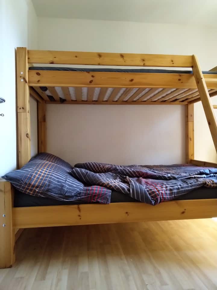 Large double bed with a bunk bed