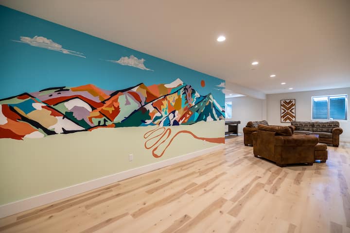 The home's downstairs level features a custom mural by local artist Madison Perrins