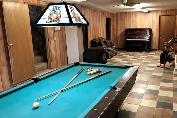 Rec room with pool table, ping-pong, piano, and old exercise bike
