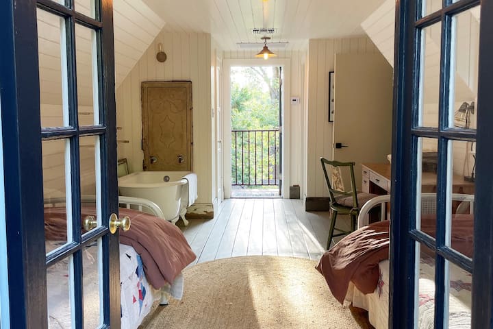 French doors on second floor on Guest house open up to private balcony overlooking property.