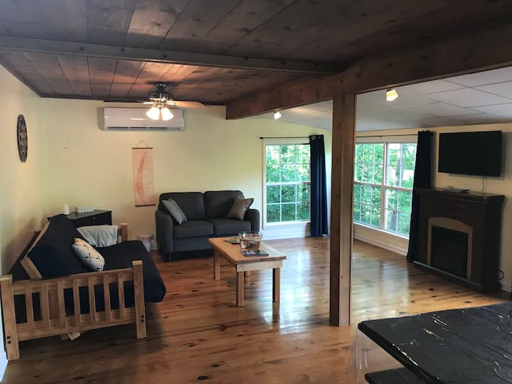 The living room has an electric fireplace, Roku TV, sofa and a comfy full-size futon which can sleep 2. There are beautiful views of the property from the many windows facing the lake.  