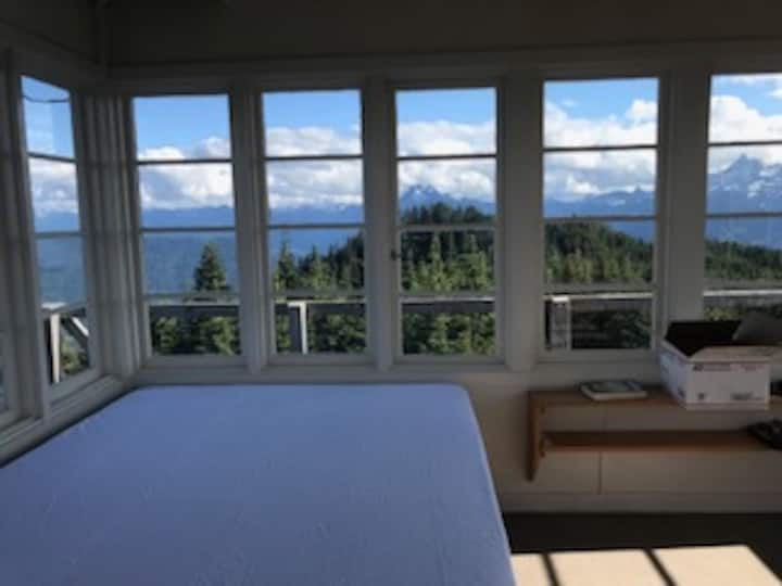 The queen mattress has a waterproof cover pad, but you cover it with your own sheets/blankets/sleeping bags as you prefer.  (Those are Jumbo and Whitehorse mountains in the photo)