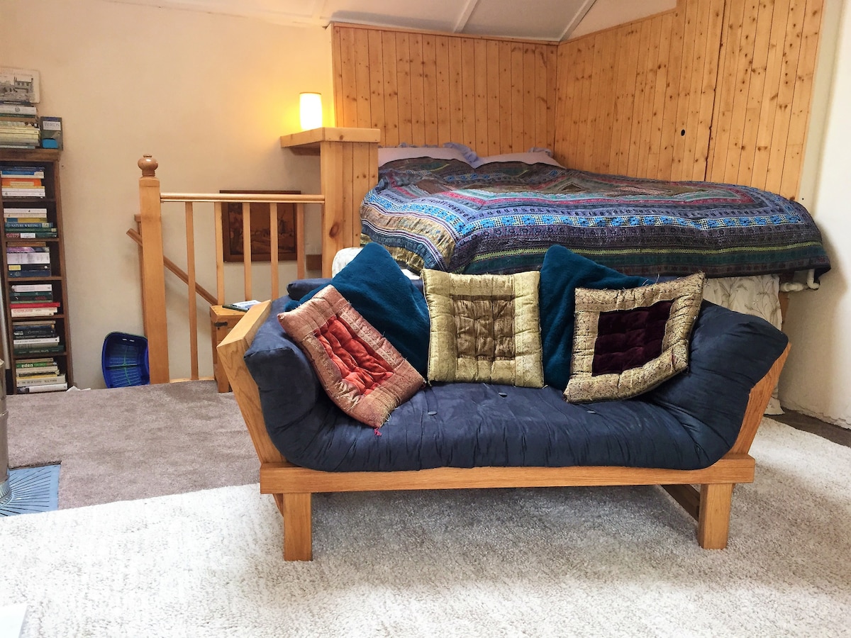 The Bedroom/Lounge area has a raised platform king size bed with a wonderfully comfy mattress, down duvet and electric blanket “like heaven” - and a sofa/chaise longue with cast iron stove upstairs for a cosy evening in.