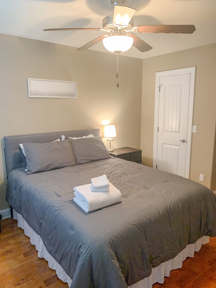 Main level guest bedroom features a queen bed and private access to the main level guest bathroom. 