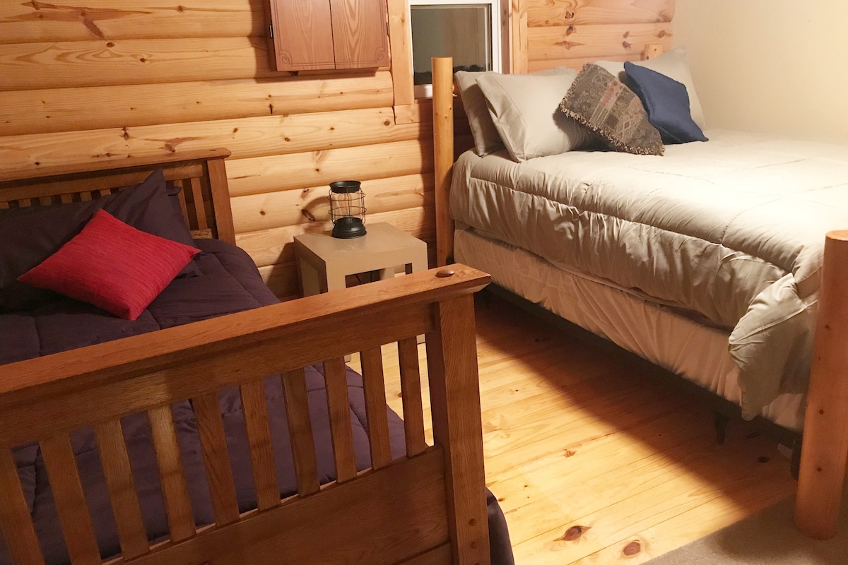 Loft sleeping room with a full and twin-size bed. Both lofts have a privacy screen, games, and books.  