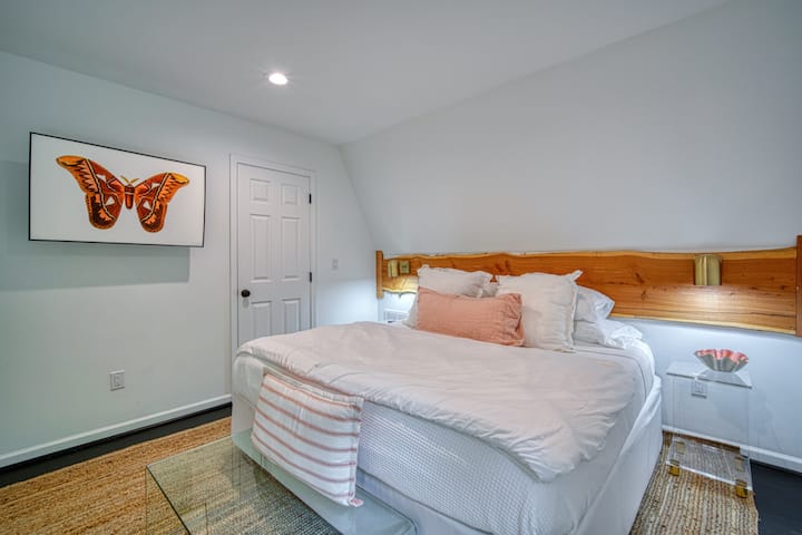 Ground floor master bedroom with 2 king-size beds & French doors opening to back deck. (Bed A)