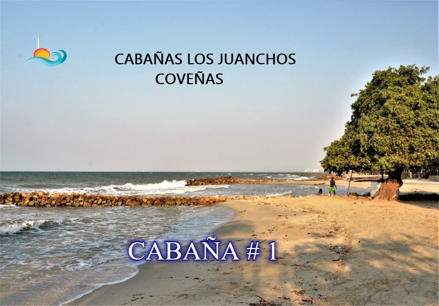 The beachfront scene features golden sand leading to the calm blue water of the Caribbean Sea. Lush greenery borders the area, providing shade. The horizon showcases a clear sky, enhancing the beach's serene atmosphere, inviting guests to enjoy a relaxing day by the seaside.