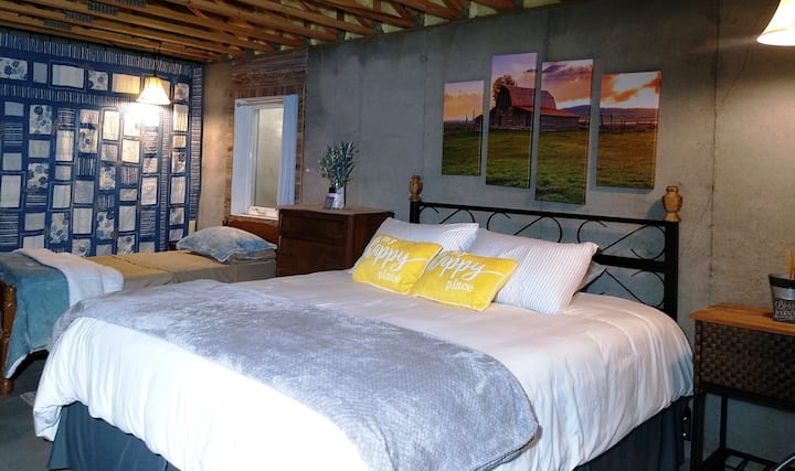 An oversized bedroom option with a California King bed and a twin bed together. A walk-in closet space nearby to allow for privacy when changing clothes.