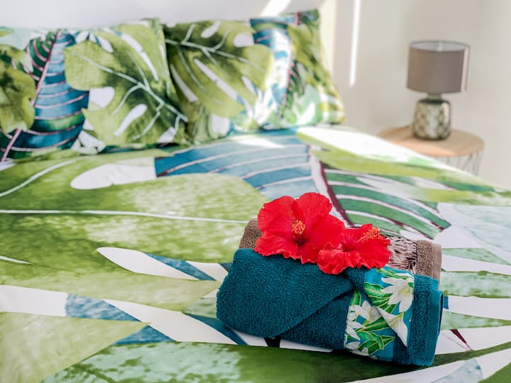 Cómoda cama de dos plazas adornada con sus bonitas toallas de baño