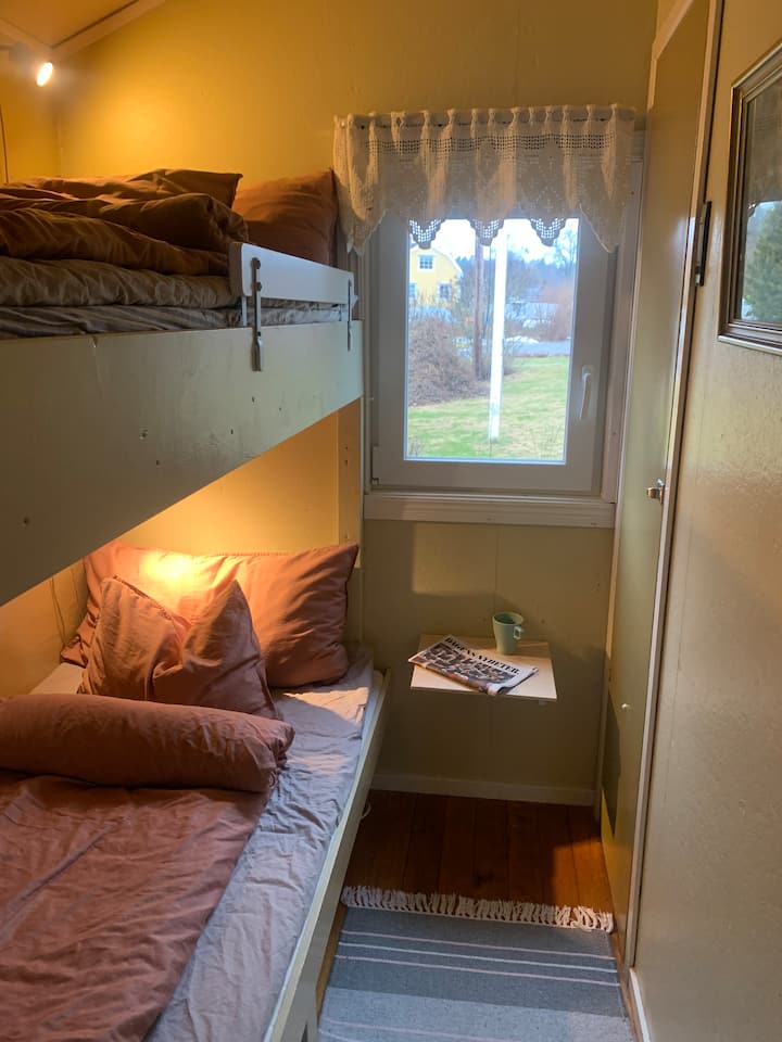 Small bedroom with two floor bed and wardrobe.