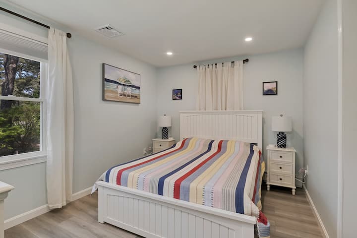 Bedroom 2 features a queen-sized bed, closet & Smart TV