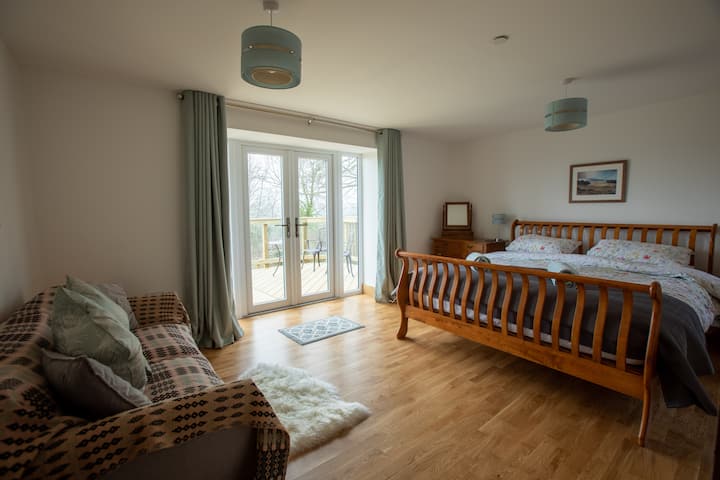 superking sized bed with ensuite and French doors onto decking